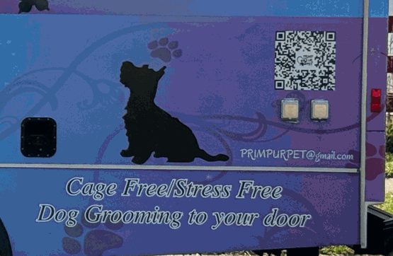 The back of the van wrap with a Scottie silhouette and the words Cage Free/Stress Free, Dog Grooming to your door