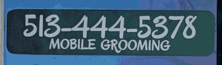 The phone panel on the van: 513-444-5378, Mobile Grooming